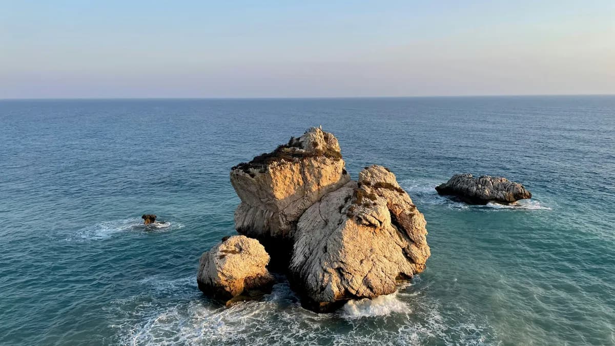 brown rock formation on sea during daytime